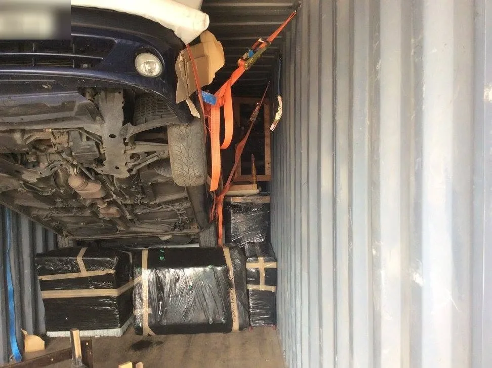 Car and packed household belongings loaded for relocating and moving back to Africa