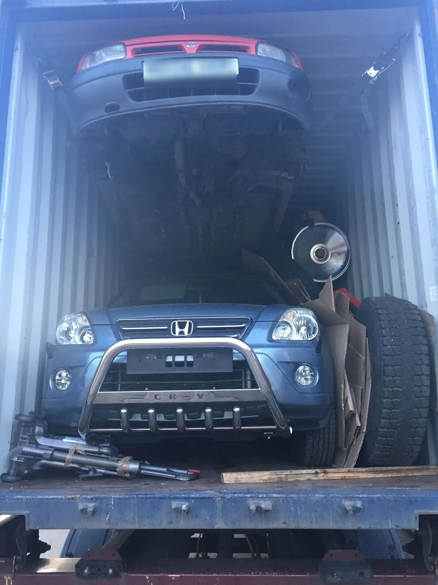 Cars loaded and secured inside a container for car shipping from the UK to Nigeria