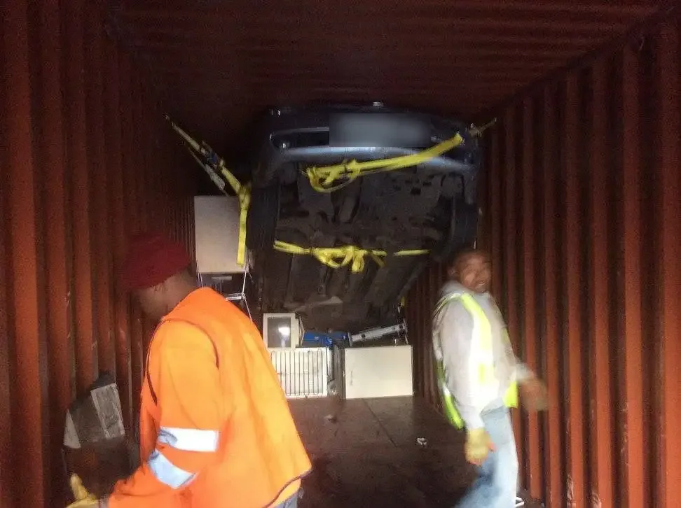 Rolats Services team securing a vehicle inside a container as freight forwarders to Africa